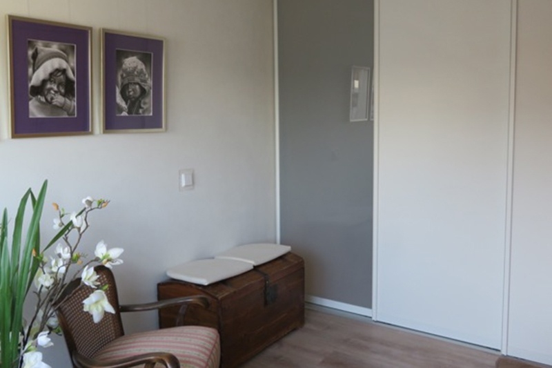 Flur und Wohnzimmer unterteilt durch Raumteiler Schiebetüren mit weißem Dekor und Milchglas